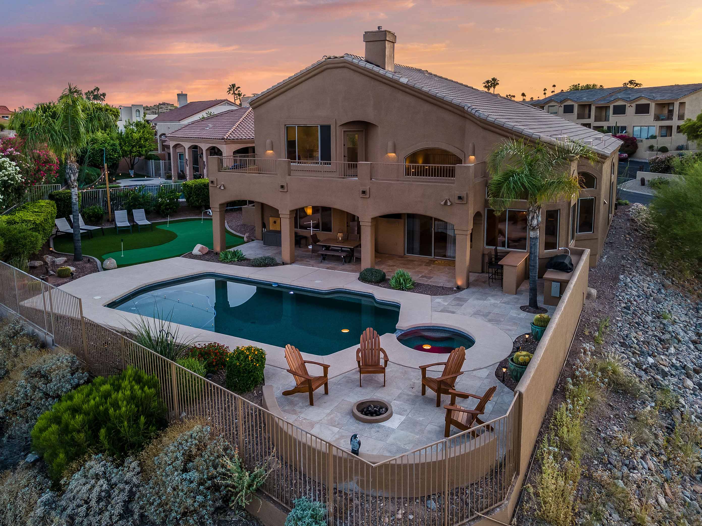 drone image of a property's backyard with a fenced pool